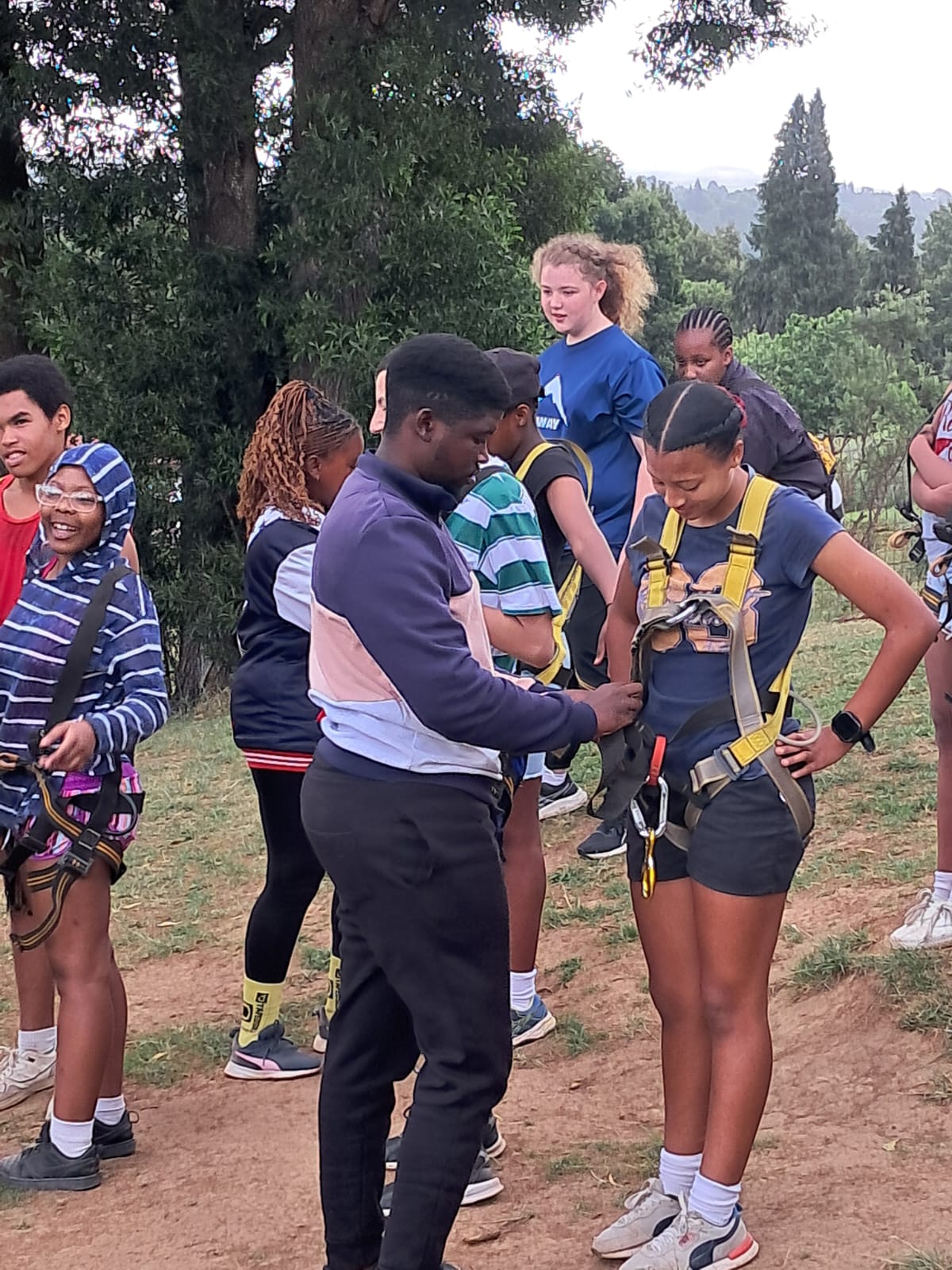 Enlin getting strapped in for the High Rope course