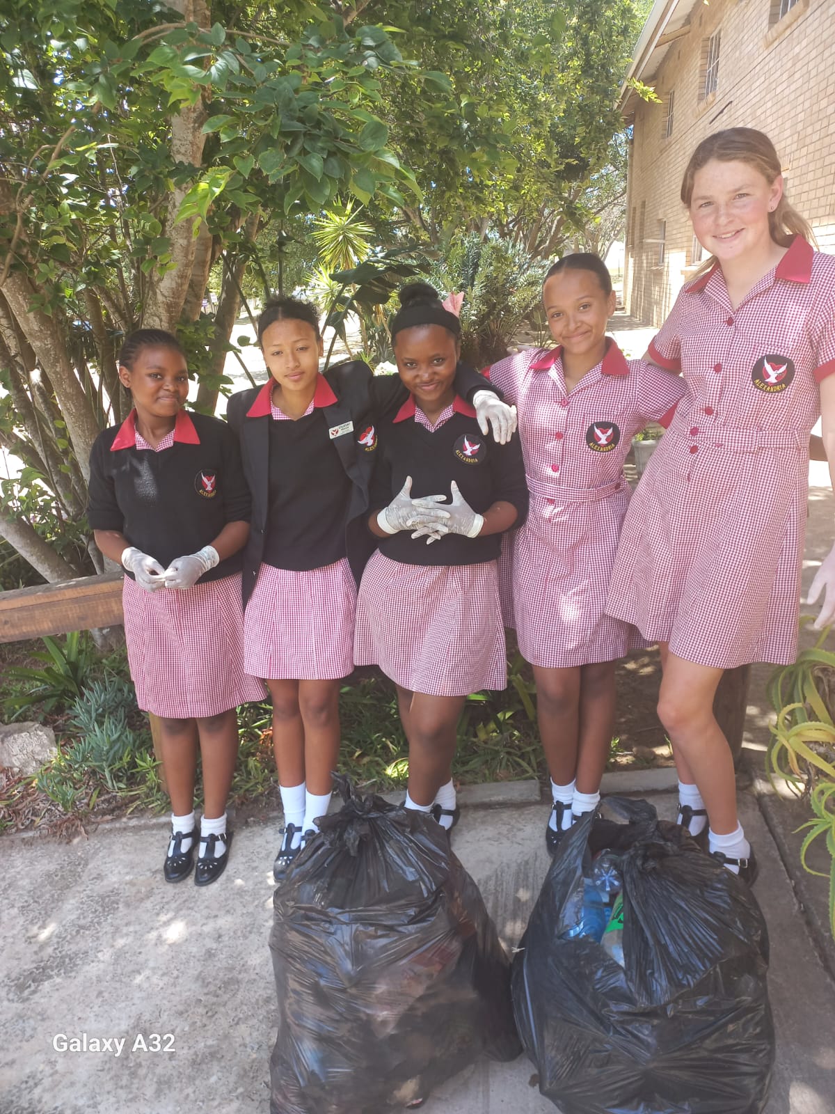 Akhile Cengani, Enlin Wentzel, Azole Hobongwane, Kate-Lynn Cannon, and Sume Bakkes successfully collecting two full bags of litter.