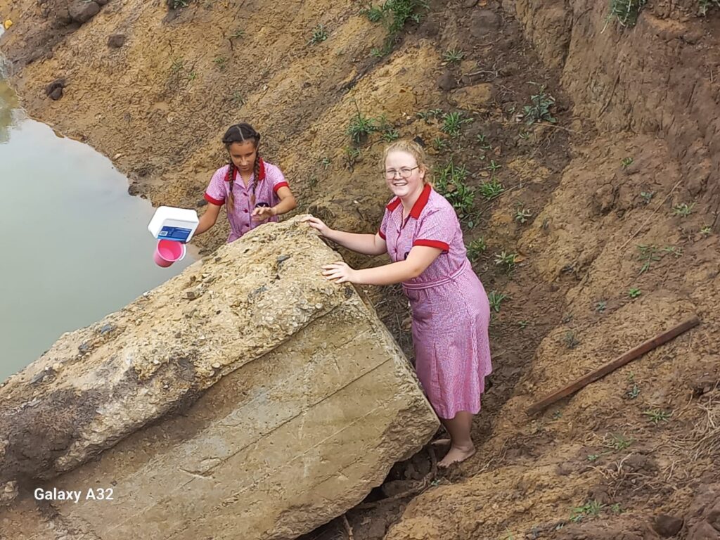 Christine Schutte and Kayla Bothma harvesting water to test.