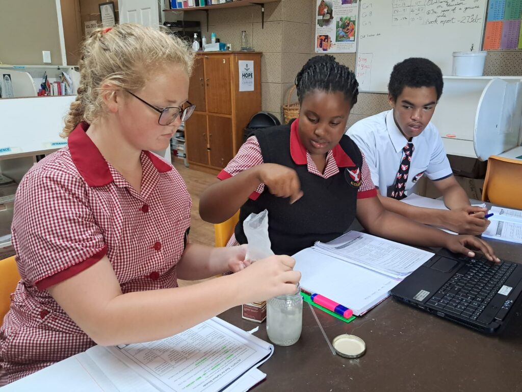 Kayla Bothma, Enzokuhle Maqwili and Benjamin Trollip testing for carbon dioxide.