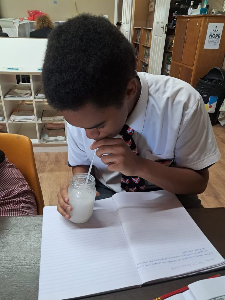 Benjamin Trollip bubbling air through the beaker for observation.