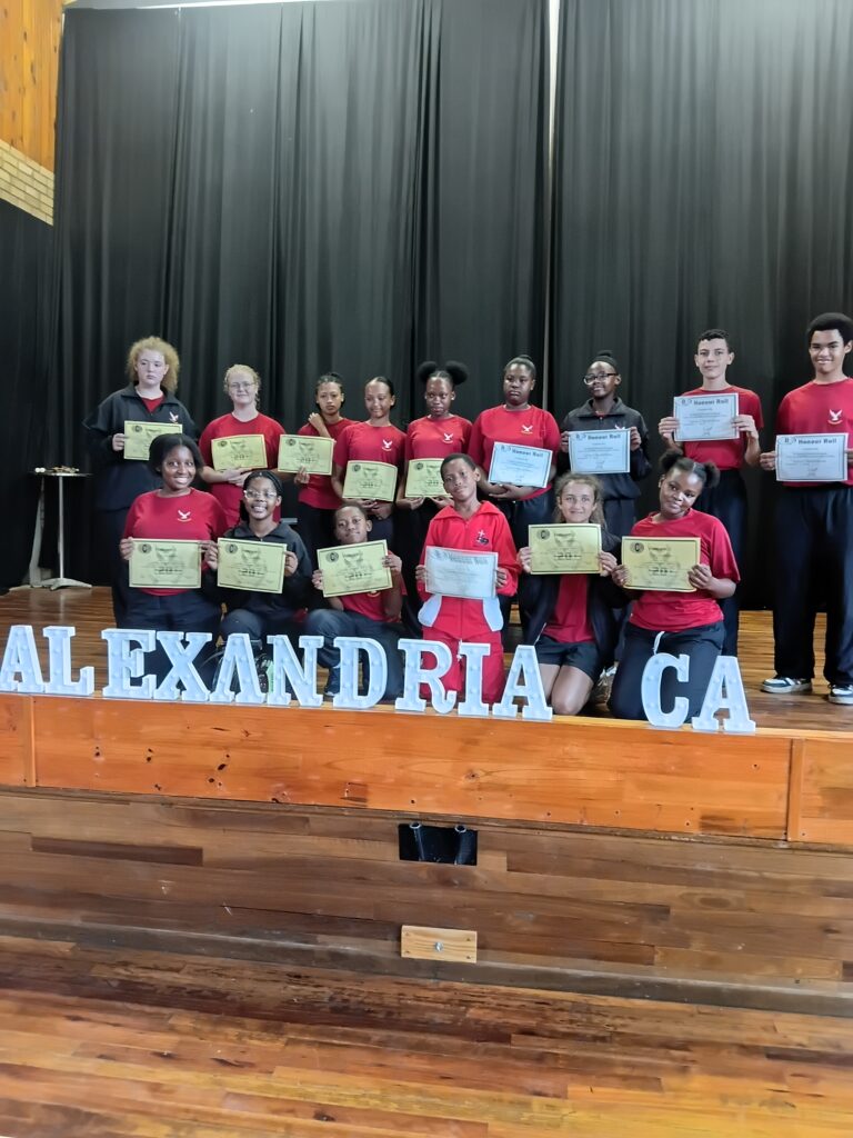 Grade 7 to 9 learners with their Honor Roll certificates.