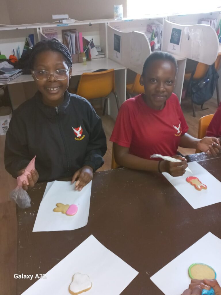 Olwenene Penze and Luthimna Speelman making their Easter bunny cookies during art class.