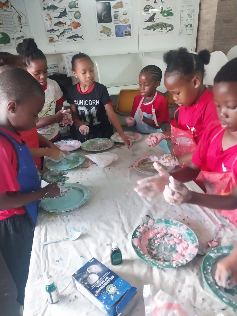 Grade 2 and 3 learners making playdough for their Science class.