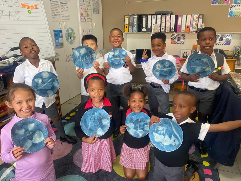 Grade 1 learners show off their final sun print creations.