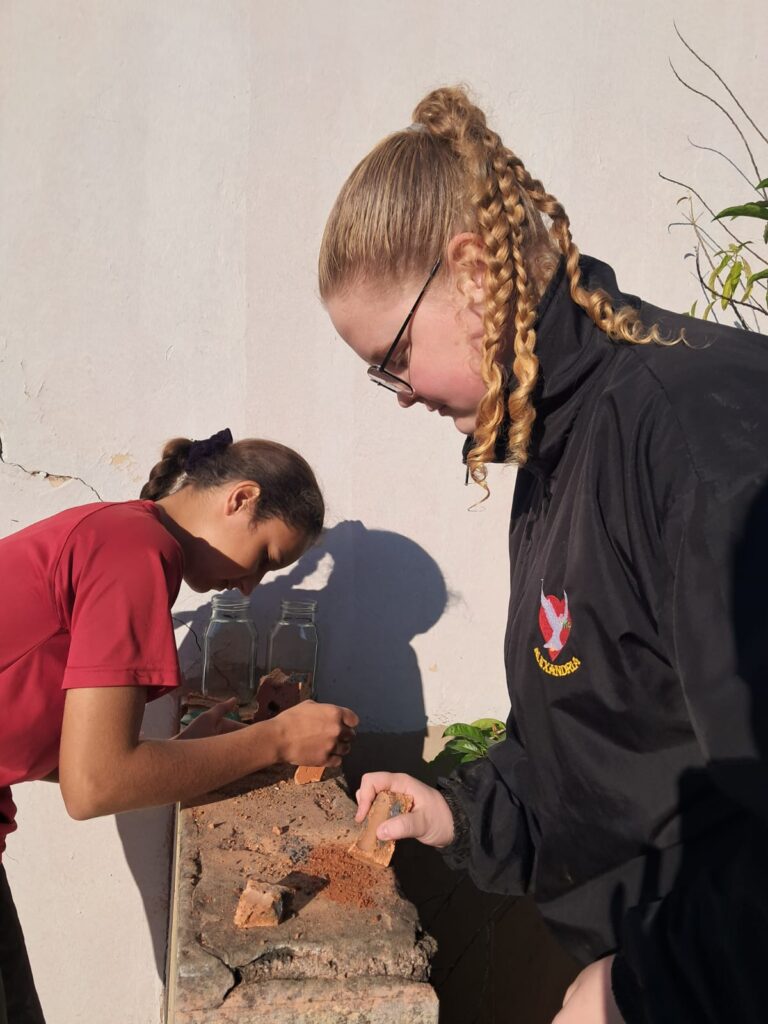 Kayla Bothma and Christine Schutte working creatively on their art project.