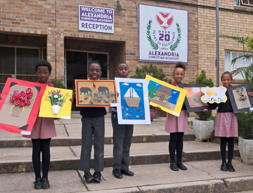 Grade 3 learners proudly showcasing their artwork that returned from the Eisteddfod competition.