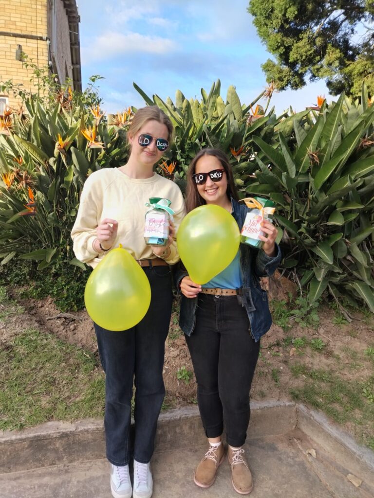 Anke Bosman and Mia Schutte celebrate 40 days of school with gifts from fellow learners and staff.