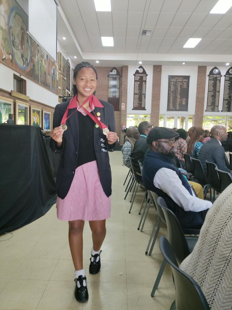 Enlin Wentzel proudly displays her bronze medals for high jump and long jump at the AASC.