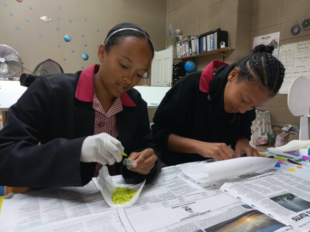 Kate-lynn Cannon and Enlin Wentzel explore the rock cycle during a hands-on science experiment.