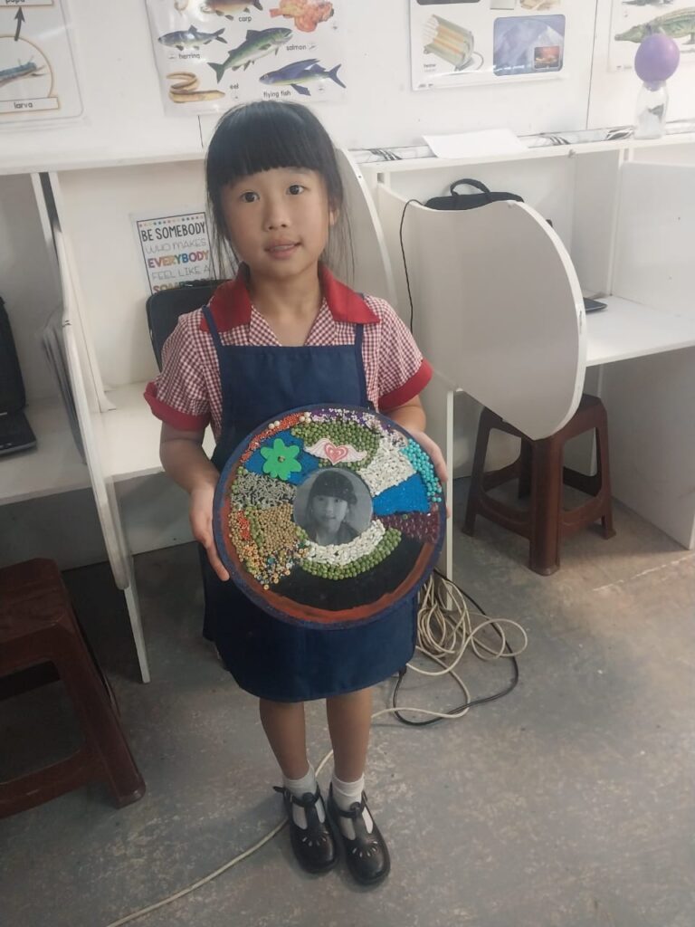 Sunny Chen proudly showcases her artwork.